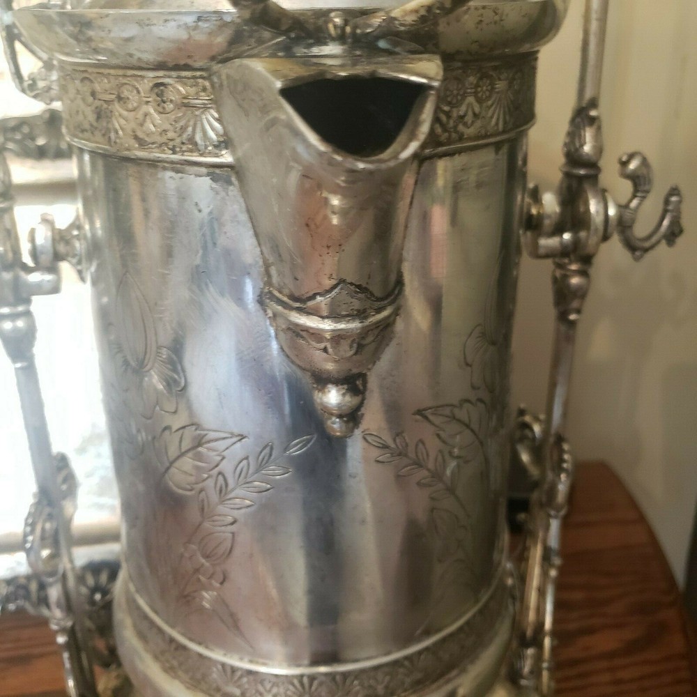 James W. Tuft silverplated tilting water pitcher. 20" tall. 