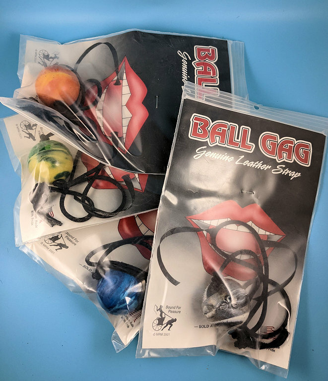 Colorful ball gag with leather strap.