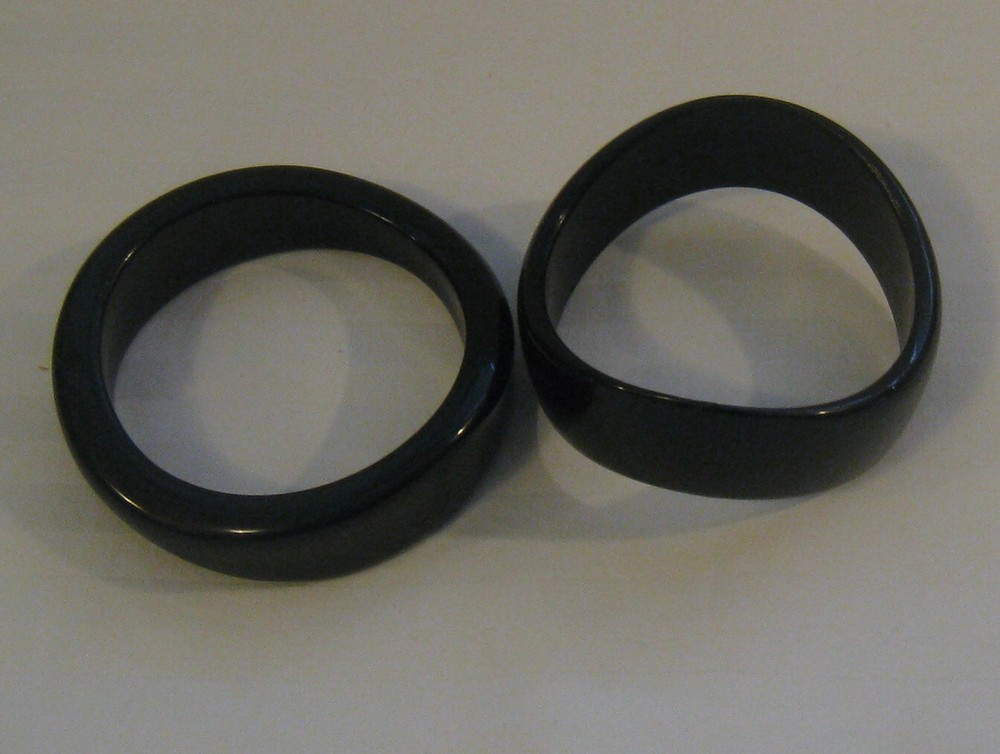 PAIR MID-20TH C. MODERN BLACK TORQUED QUALITY PLASTIC BANGLES:
