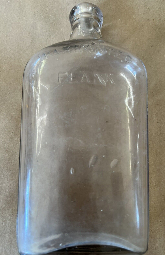 EMBOSSED WARRANTED FLASK C-14 ON BOTTOM CLEAR GLASS