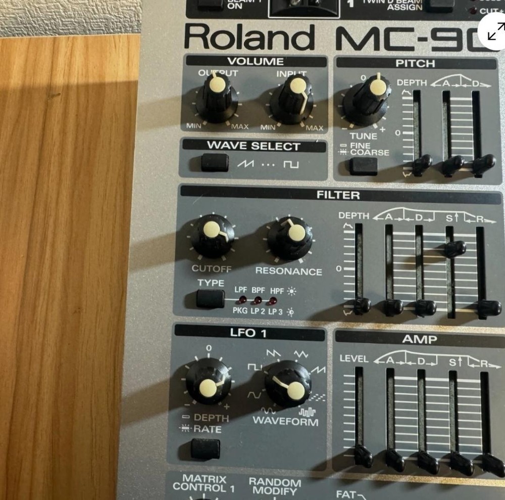Roland MC-909 rhythm machine with adapter