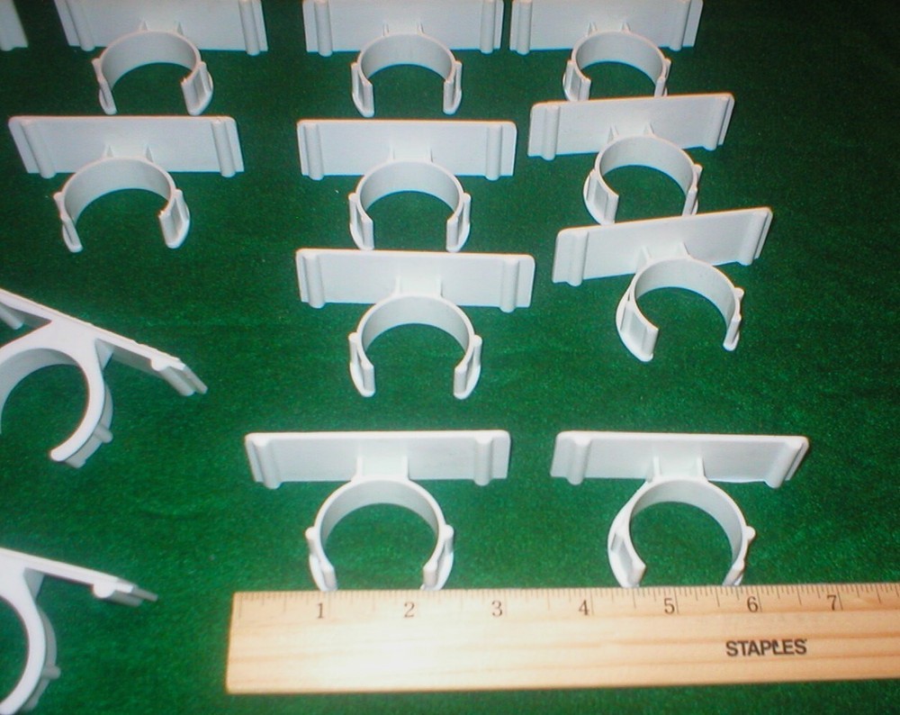 25 WHITE PLASTIC HOLDERS WITH ADHESIVE STRIPS LOT SOLD AS IS