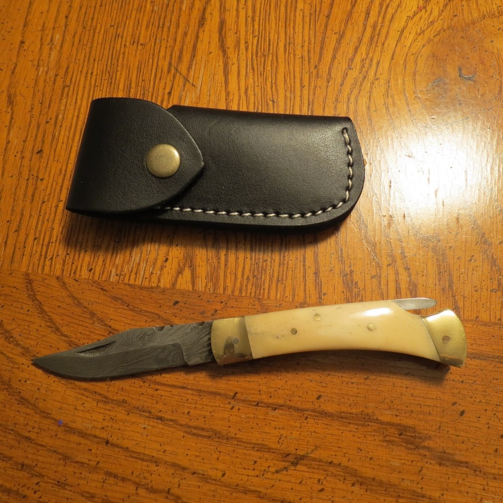 Sleek Damascus folding blade knife with white bone & leather sheath hand made