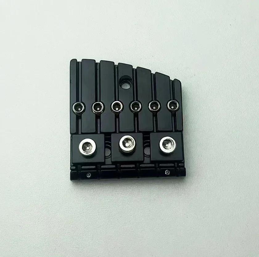 Six-string headless guitar with bridge, saddle, and nut.