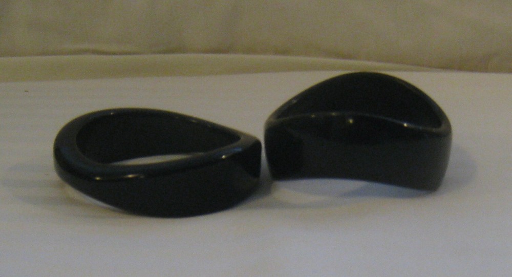 PAIR MID-20TH C. MODERN BLACK TORQUED QUALITY PLASTIC BANGLES:
