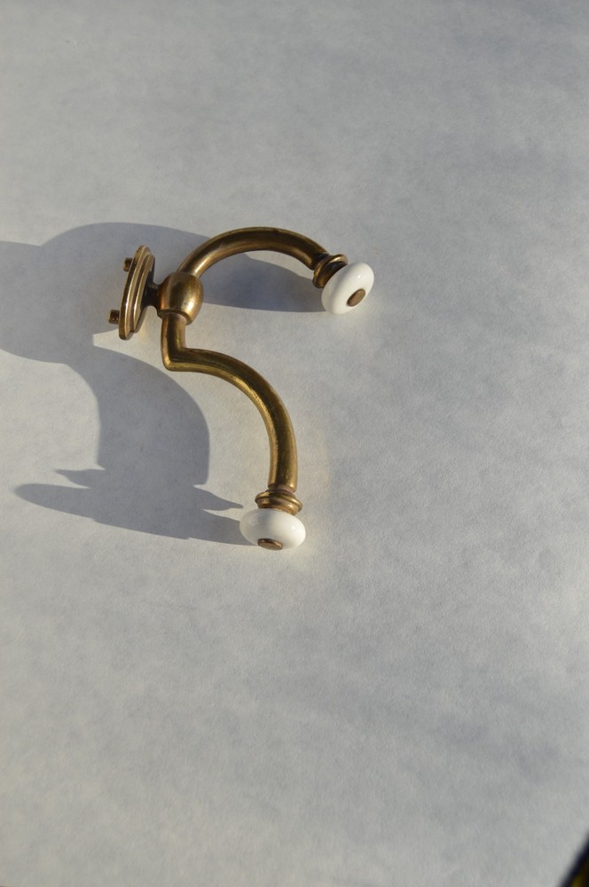 Solid brass with procelain hook  that  will hold securely is easy to mount .