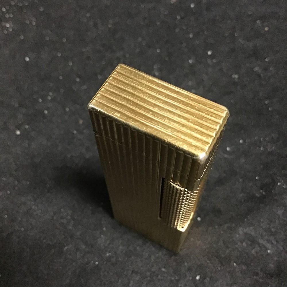 Overhauled gold dunhill lighter with striped pattern, ignition functioning well