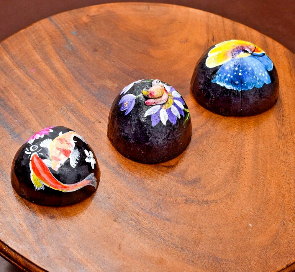 Coconut shells hand painted with different faces specified for hotel decorations