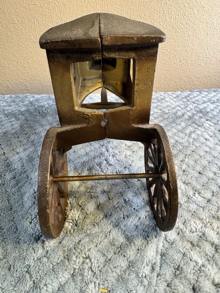 Antique cast iron pull toy carriage with decorative detailing and pull handle