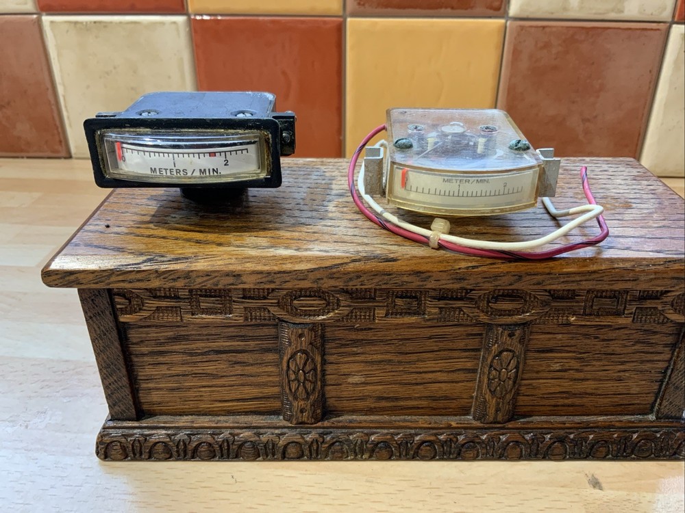 Two vintage panel meters, aircraft, meters/minute.