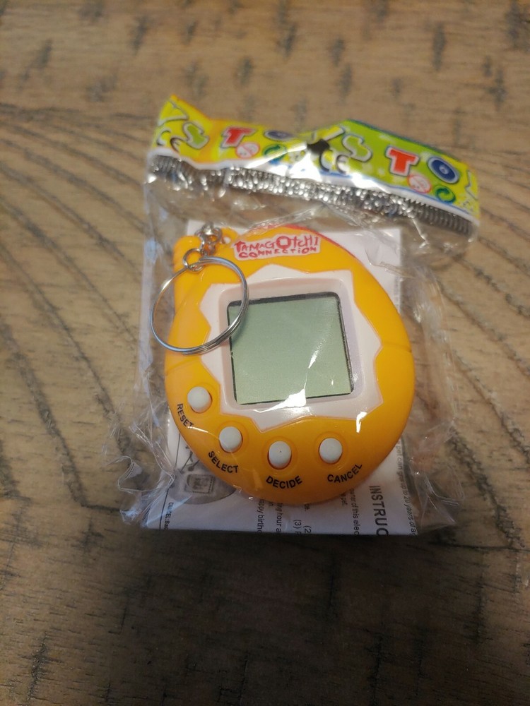 Orange Tamagotchi with dinosaur egg