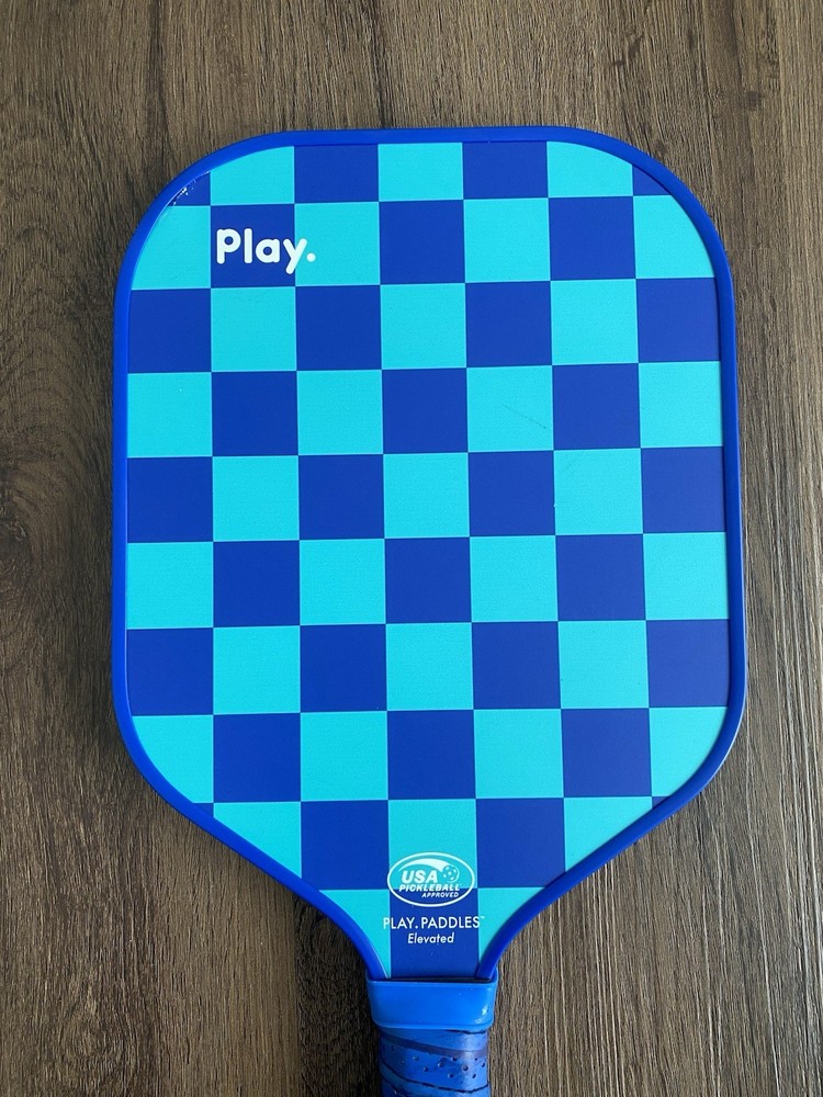 Play. Blue Pickleball Paddle Checkered Pattern Has Slight Wear On Handle