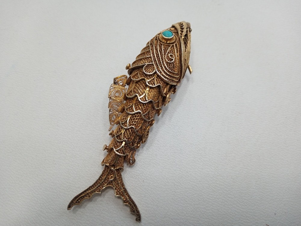 Tested as silver and gilded flexible fish, possibly pill box.