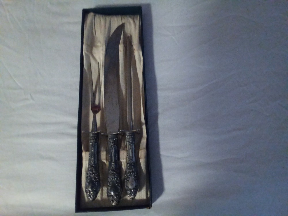 silver plated weighted handle carving set.