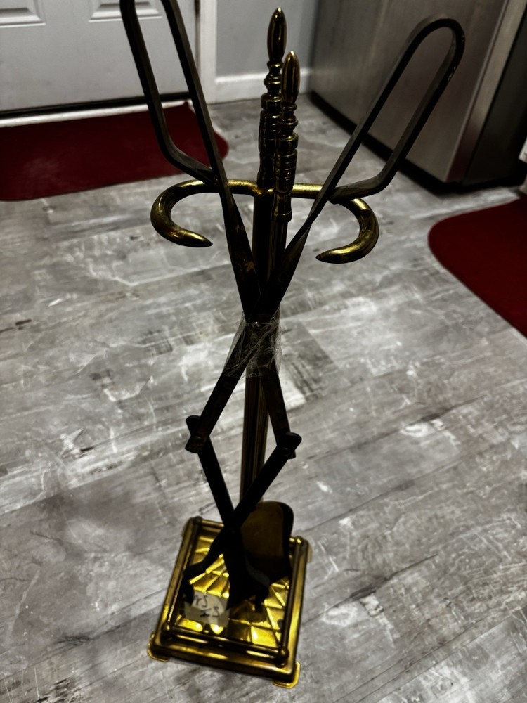 This item is a vintage brass fireplace tool set, typically featuring tools