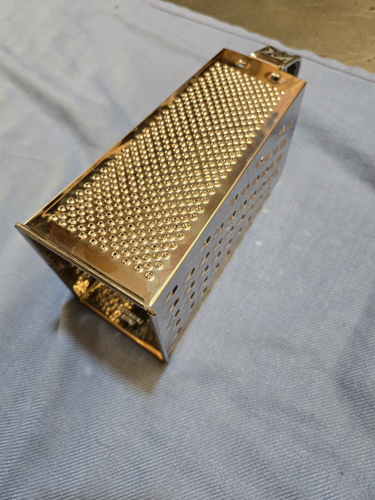 large stainless steel cheese grader