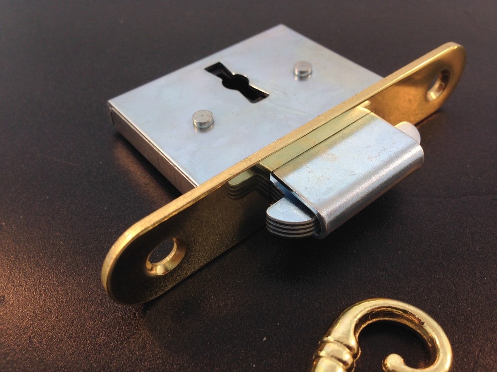 Roll-top Desk lock with self closing strike hardware