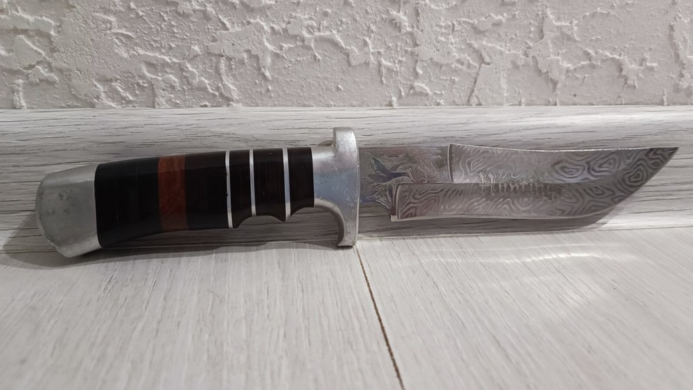 Antique handmade hunting knife with a pattern.