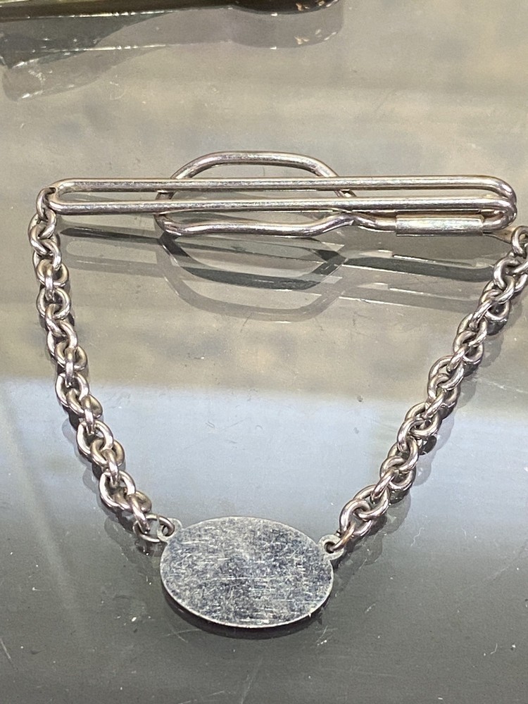 Two Tie Clips, One Marked Anson