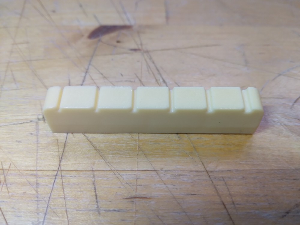 Vintage unbranded Plastic guitar Nut, white