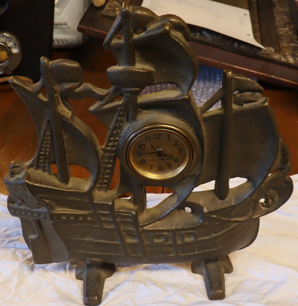 Vintage solid brass sailing ship with Lux electric clock.