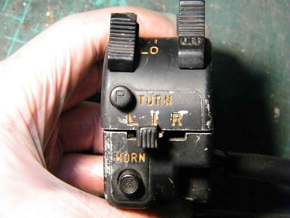 Suzuki GT550 headlight beam switch thumb toggle.
