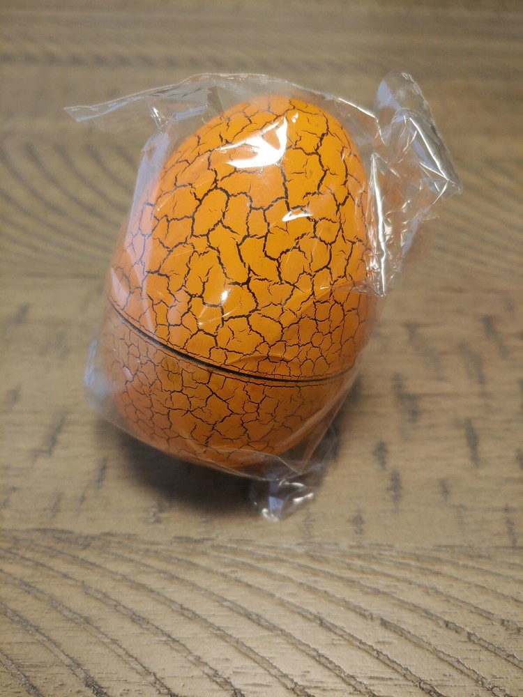 Orange Tamagotchi with dinosaur egg