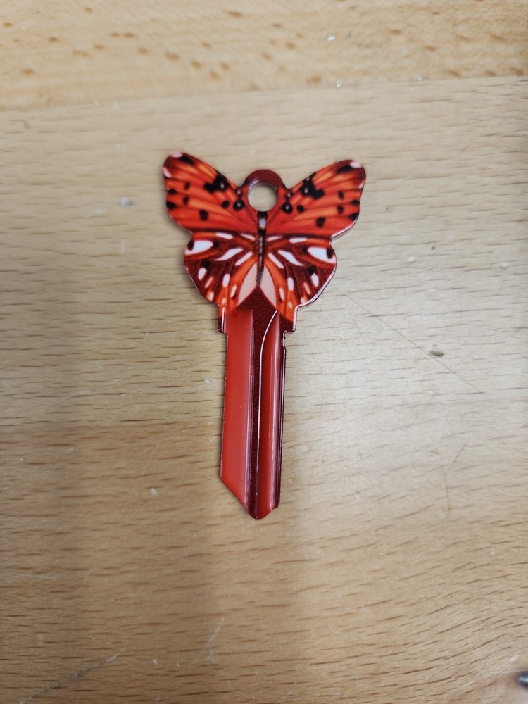 RED COLORED BUTTERFLY SHAPED SCHLAGE SC1 KEYBLANK