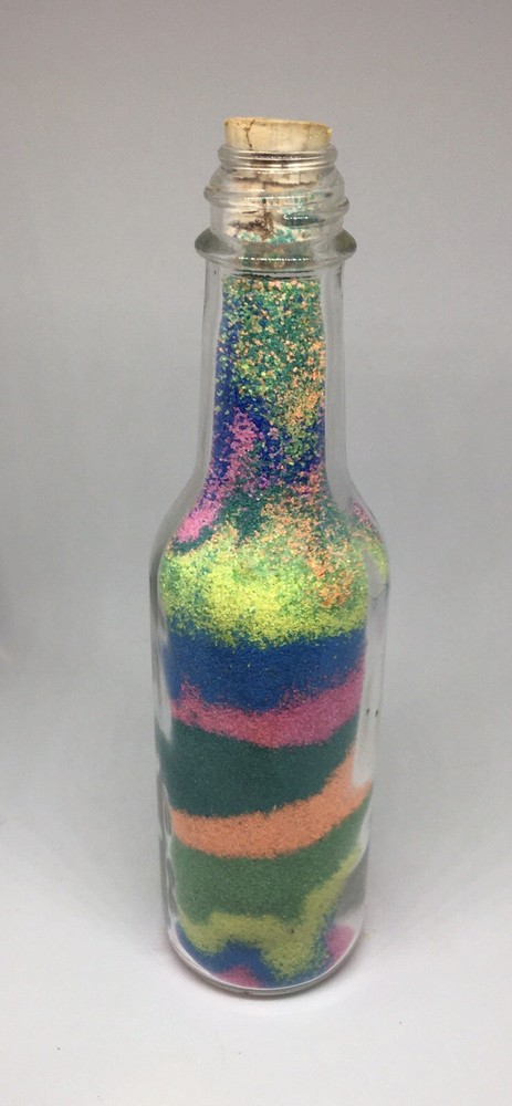 Bottle Of Multi Colored Sand And Mini Picture Frame