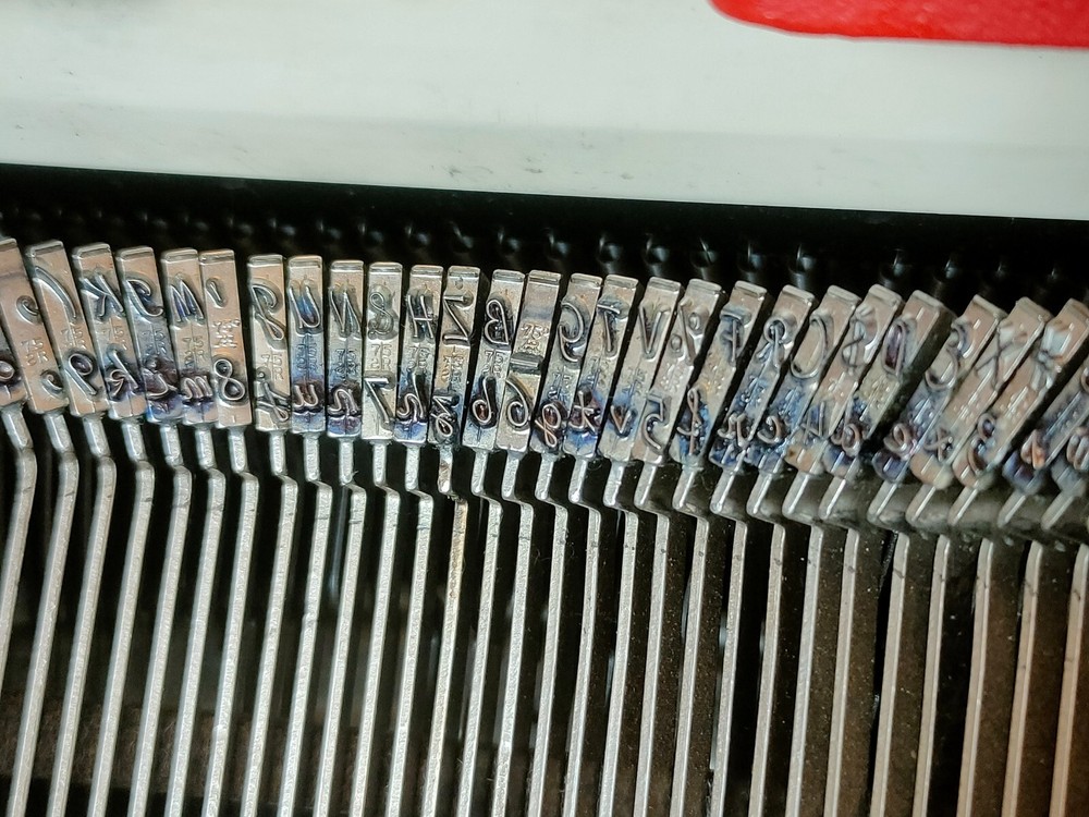 red, portable Smith Corona Galaxie typewriter with Cursive / Handwritten Script