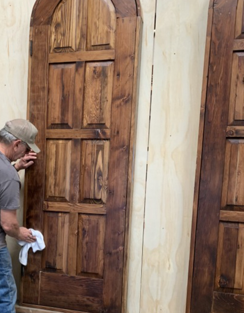 Rustic reclaimed lumber arch top door in square frame solid wood side lites