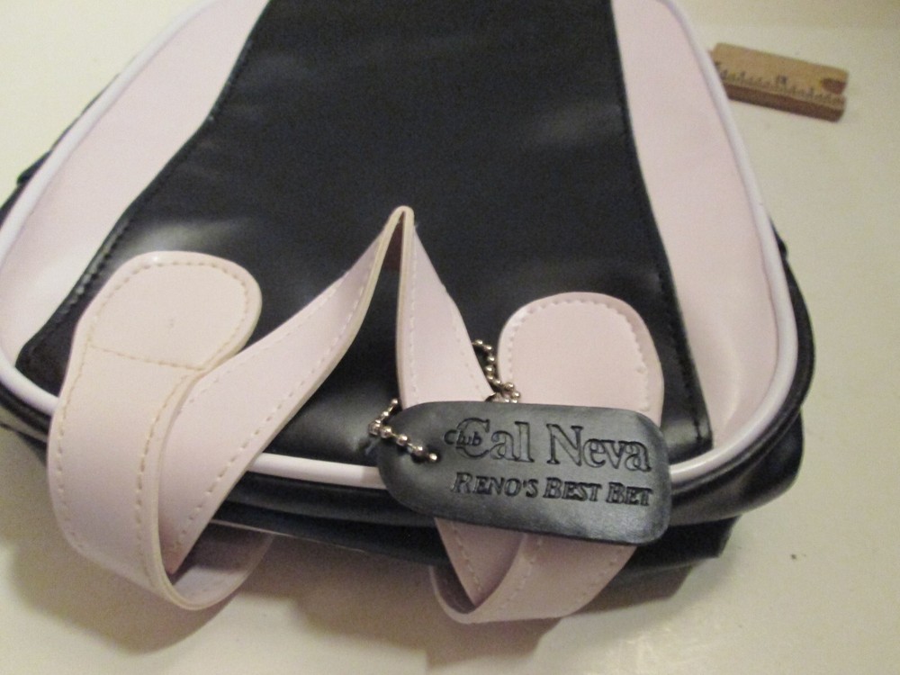 SMALL BLACK AND WHITE "CAL-NEVA" PURSE.