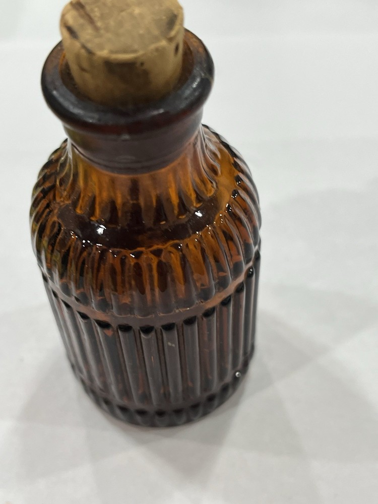 Small Amber Round Ribbed McKESSONS bottle