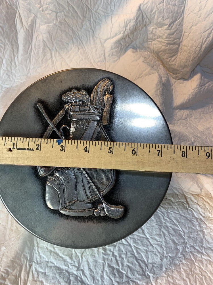 round silver tin with metal golf plaque affixed