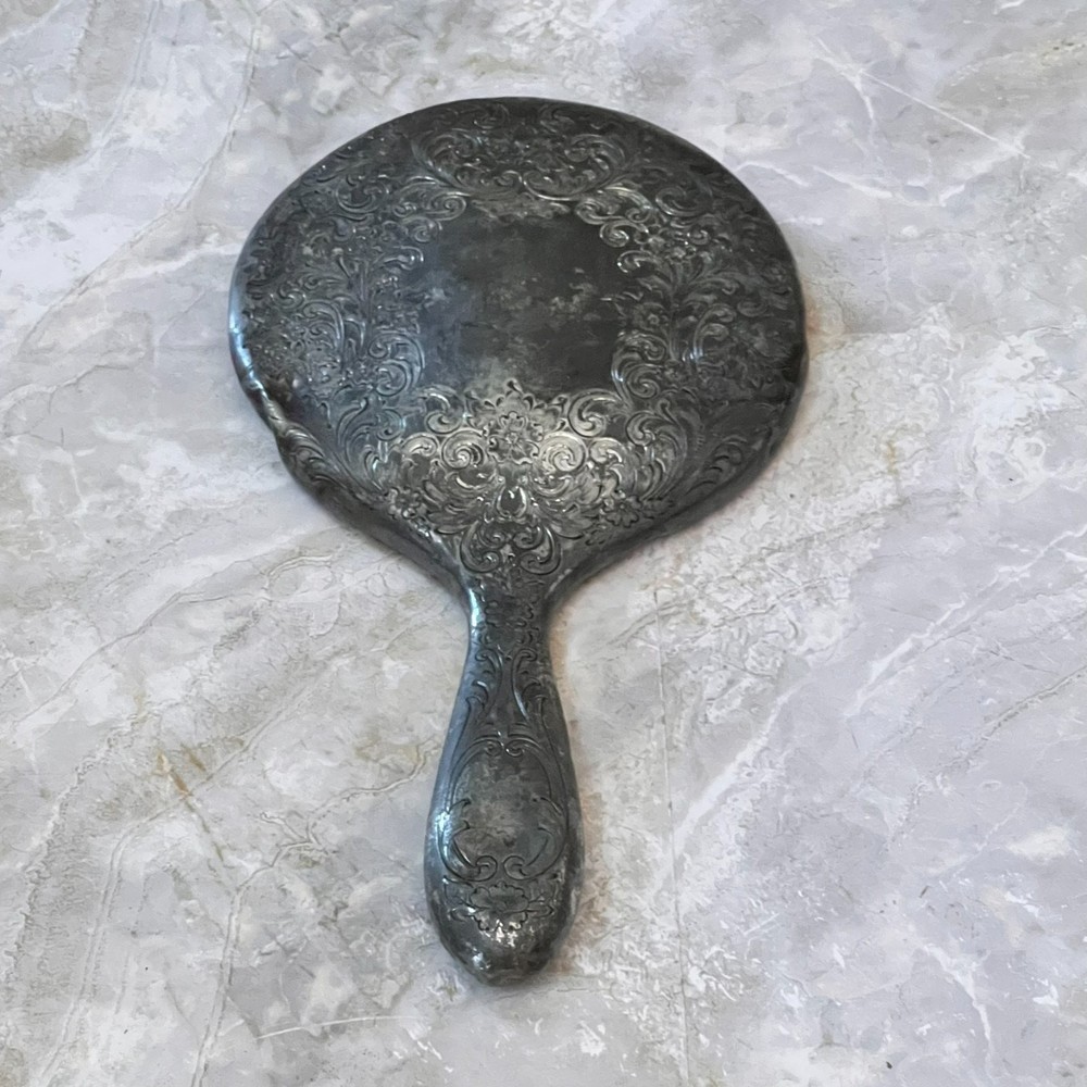 Silver Plated Hand Held Mirror with Intricate Raised Floral Scrollwork