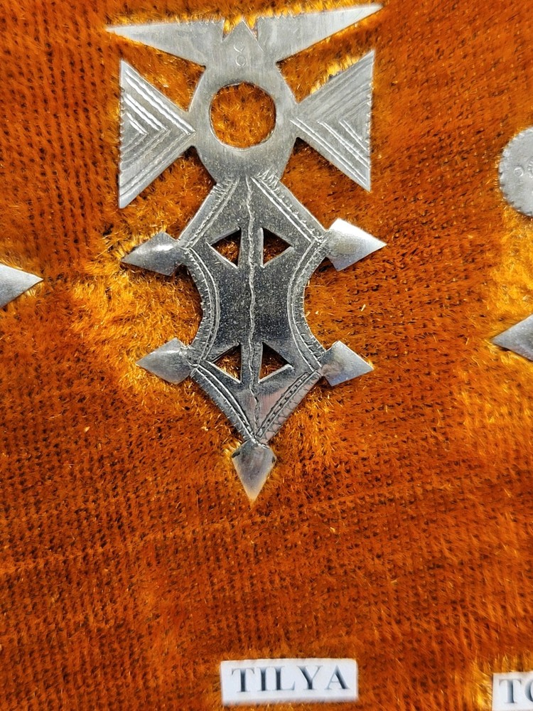 Collection of Hand-tooled Tin Badges