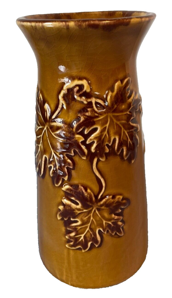 Handmade brown ceramic vase with leaves