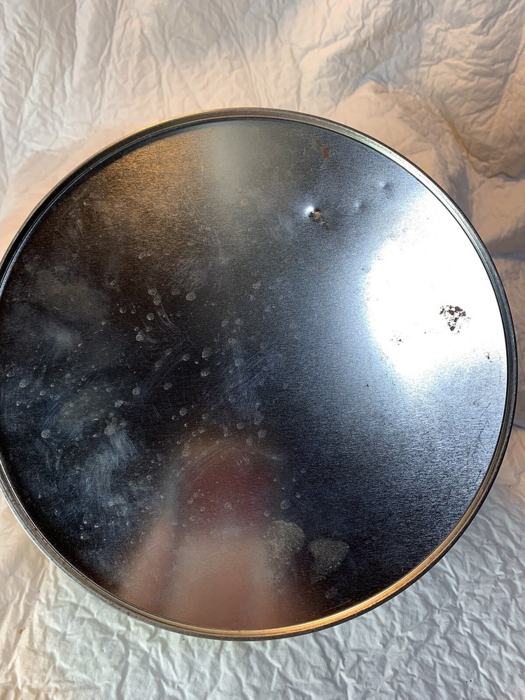 round silver tin with metal golf plaque affixed