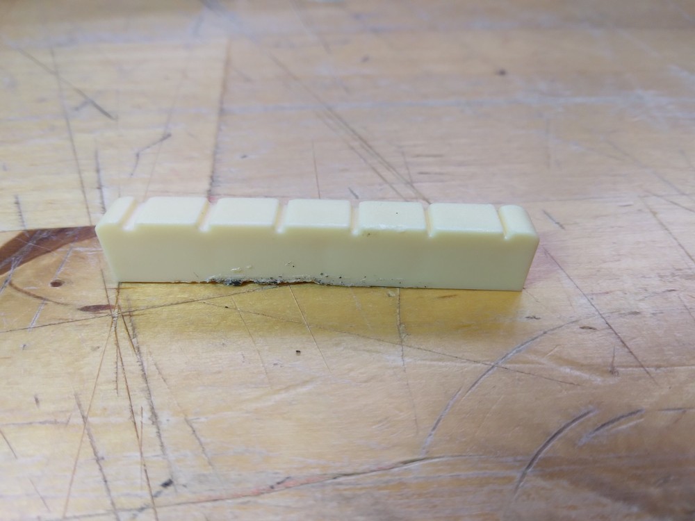 Vintage unbranded Plastic guitar Nut, white