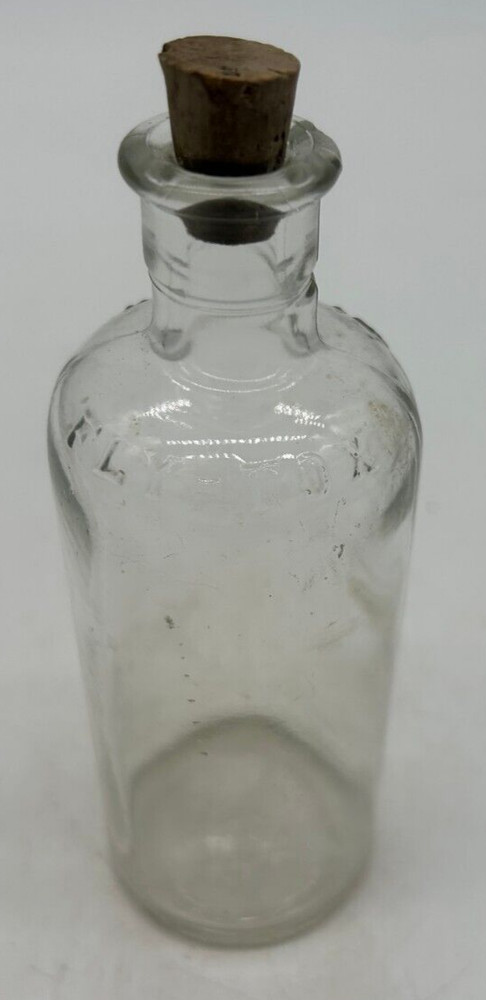 Clear small Fly Tox bottle with cork