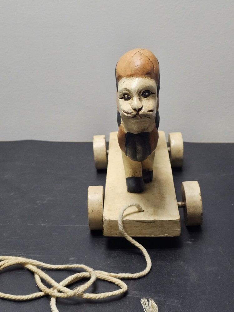 Antique Lion pull toy on wooden platform