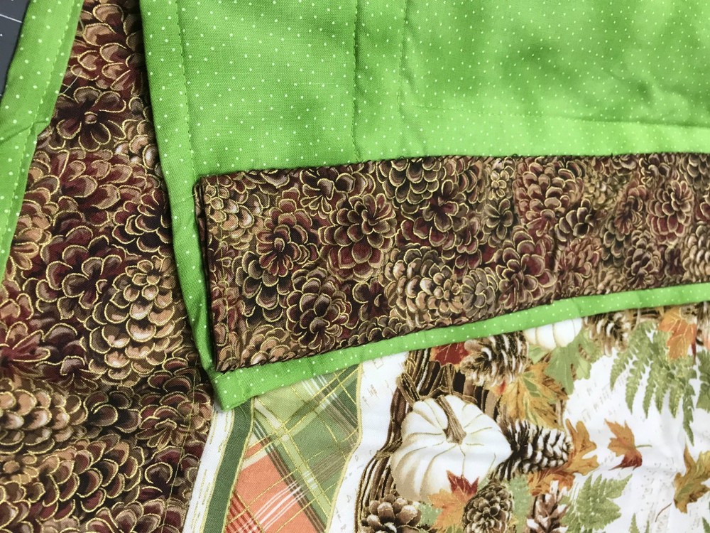 Homemade Quilted wall hanging with a fall theme pattern with hanging collar