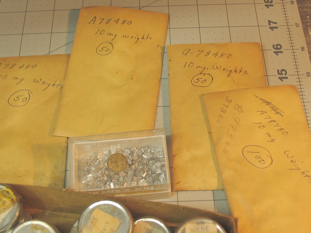 Collection of tiny marked weights 5mg-500mg.