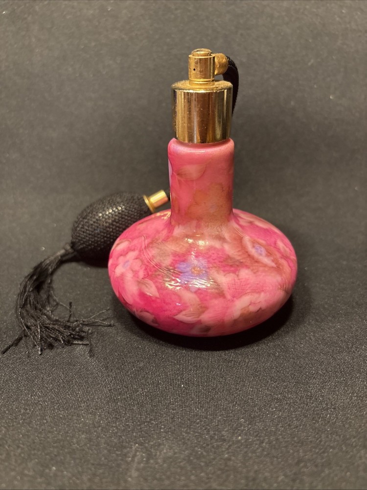 Iridescent atomizer pink perfume bottle.