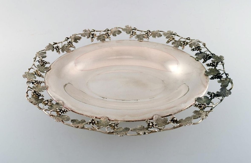Large silver bowl pierced with grape vines.