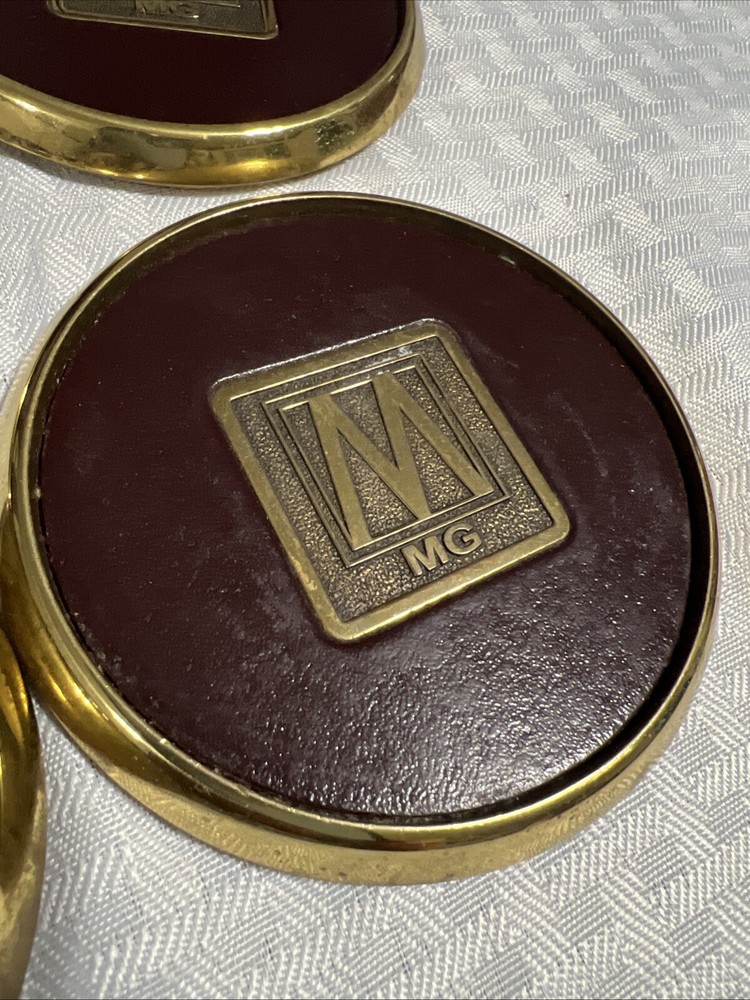 8 Vintage Solid BRASS and Brown LEATHER M MG COASTERS