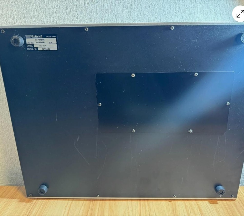 Roland MC-909 rhythm machine with adapter