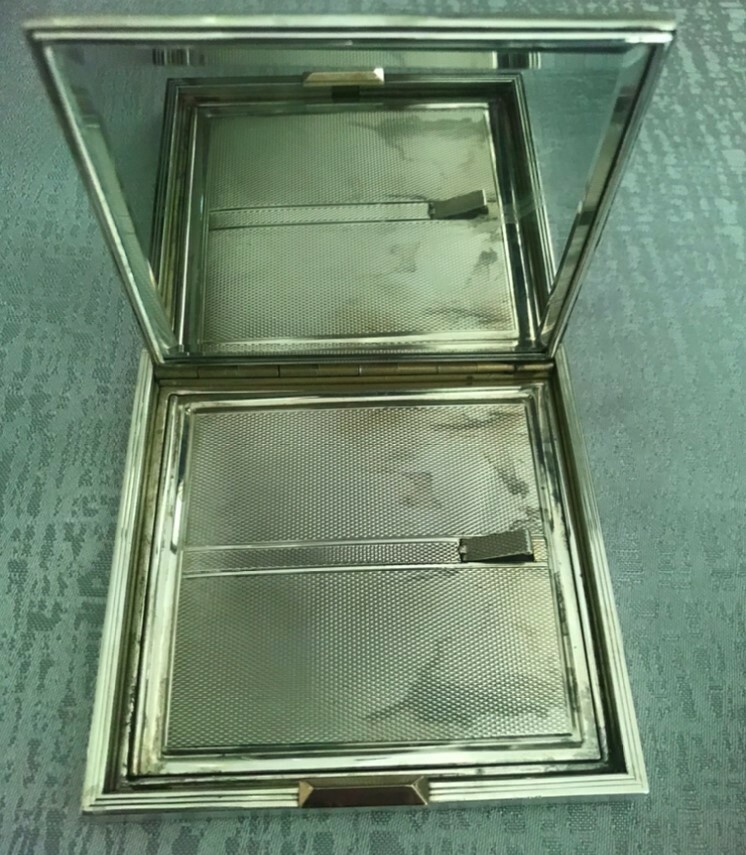 Hallmarked silver compact case with a leather cover