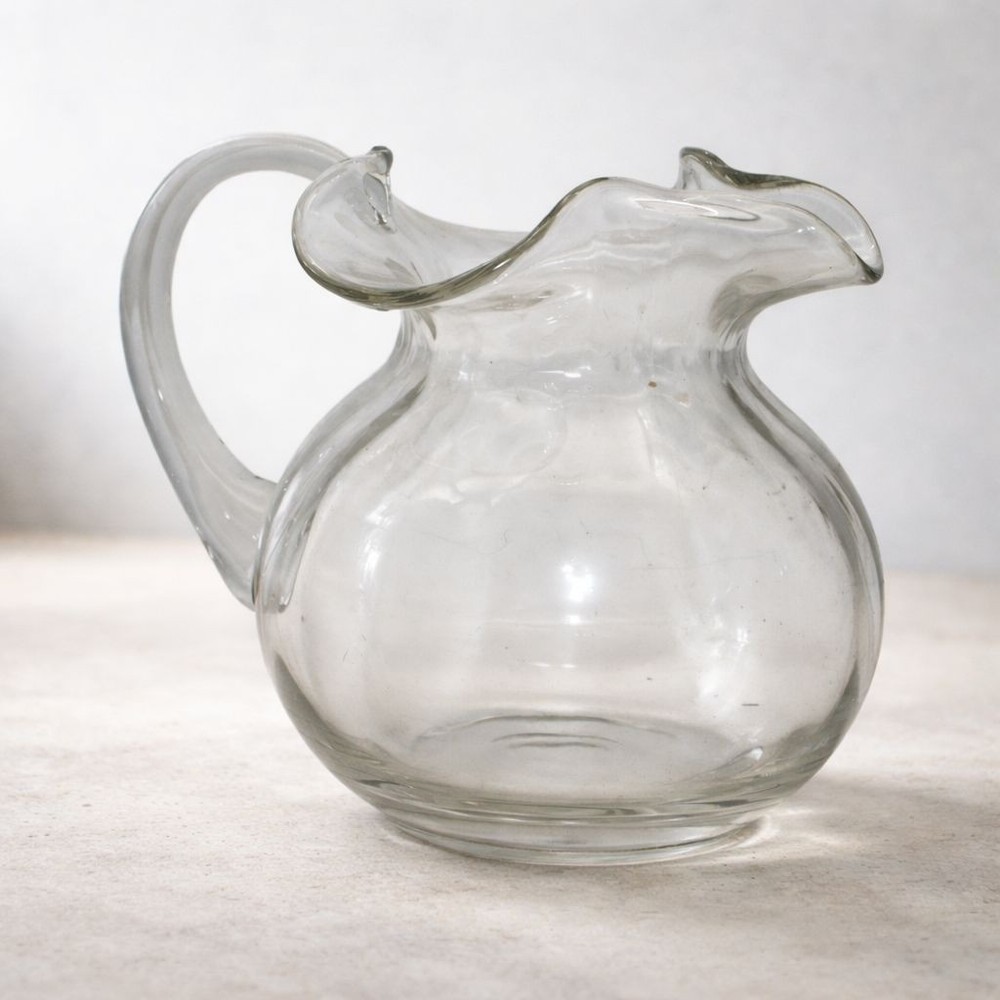 Handblown Clear Glass Pitcher With Ruffled Rim And Sturdy Handle