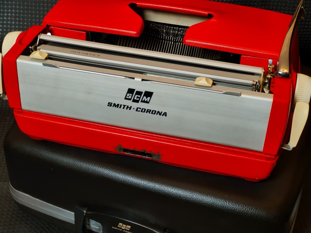 red, portable Smith Corona Galaxie typewriter with Cursive / Handwritten Script